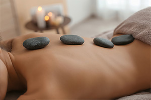 a lady enjoying a hot stone massage