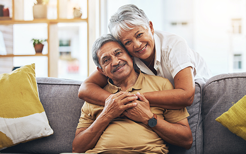 a senior couple hugging in a home