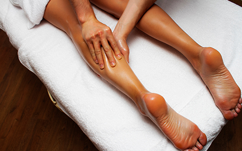 a person receiving a lymphedema massage on their leg